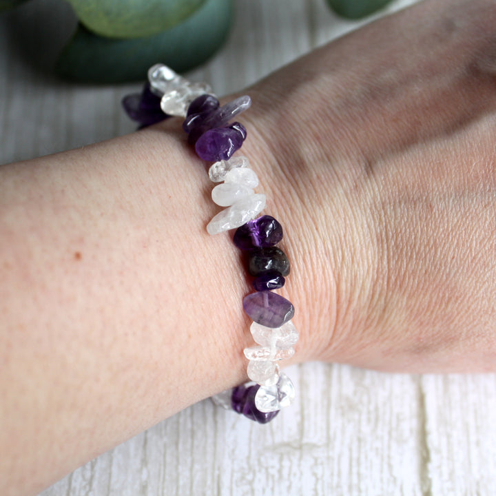 Close up of natural amethyst and clear quartz crystal chips in handmade stretch bracelet