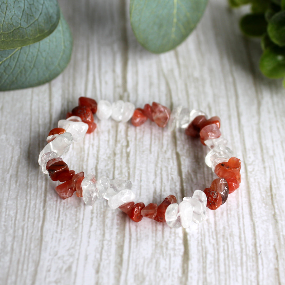Carnelian and clear quartz stretch bracelet with natural orange and clear gemstone chips on white background
