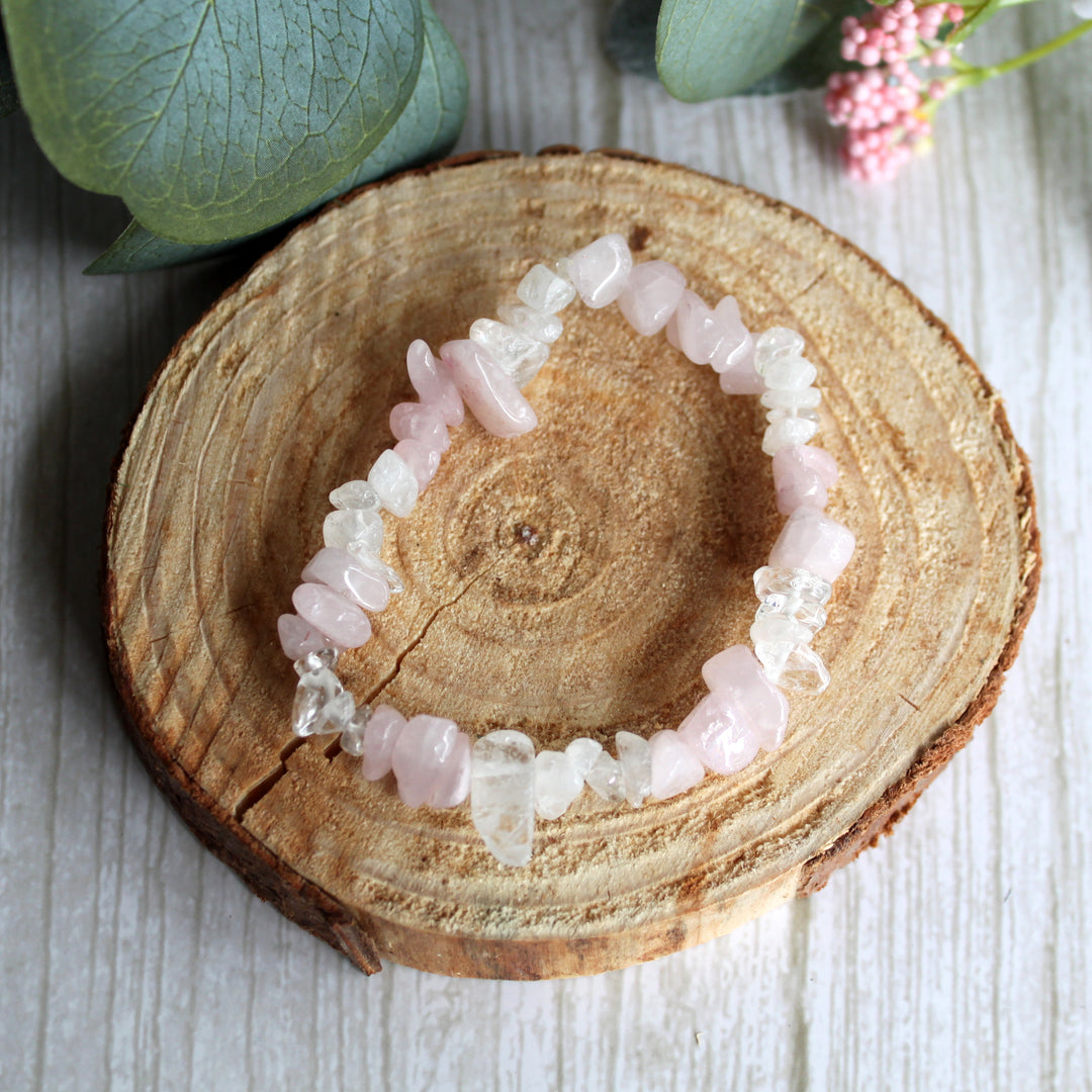 Rose quartz and clear quartz stretch bracelet with natural pink and clear gemstone chips on white background