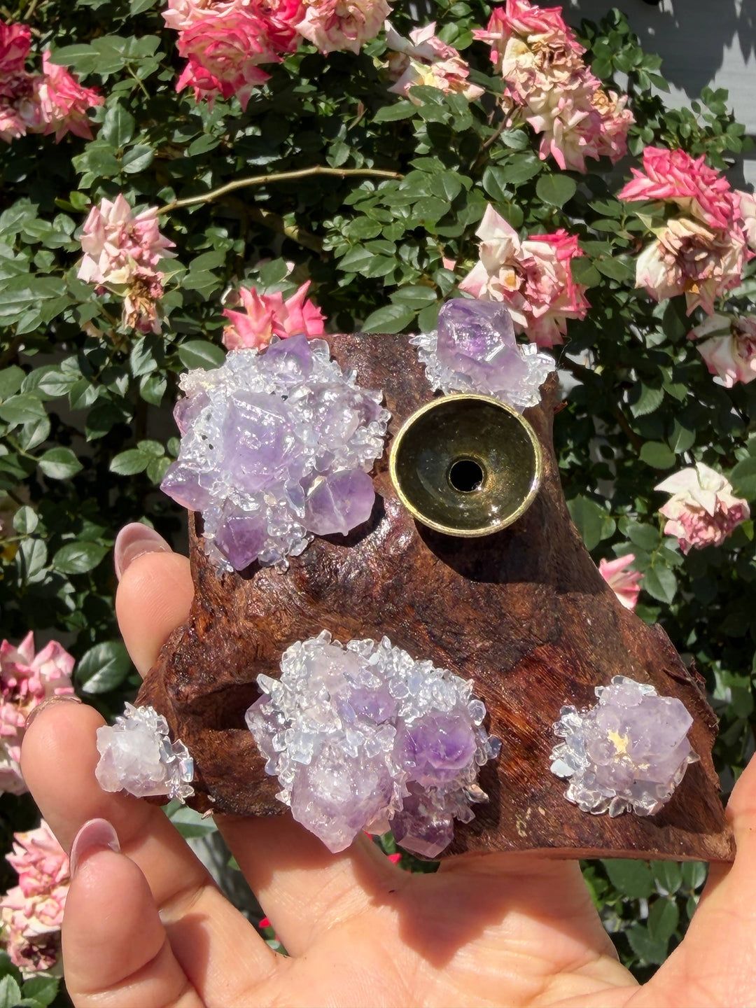 Amethyst driftwood incense holder and sphere stand held in hand showing amethyst crystal clusters and brass incense cup