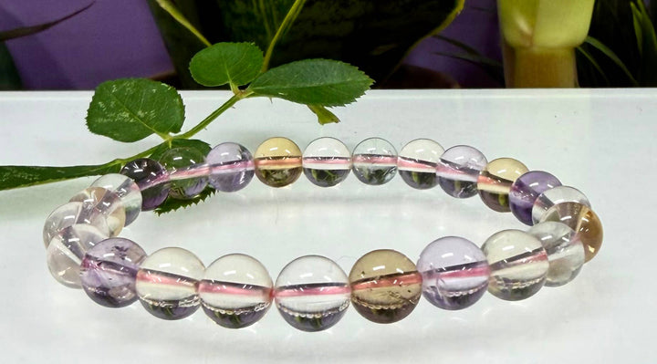 Natural Ametrine 8mm stretch bracelet laid flat showing translucent purple amethyst and golden citrine round beads
