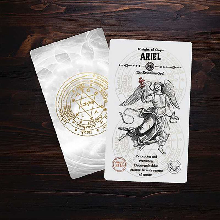 Angel Tarot Ariel Knight of Cups card alongside gold summoning seal pouch on dark wood background
