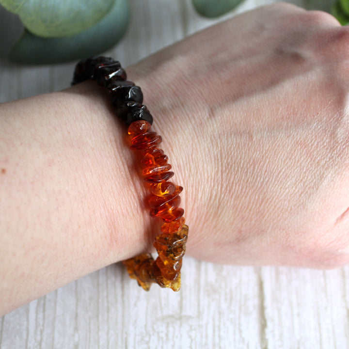 Close-up of authentic Baltic amber healing bracelet showing natural color variations and gemstone chips