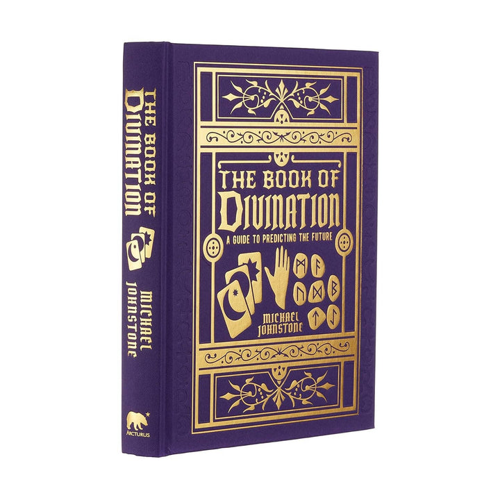 Angled view of The Book of Divination showing gold foil-embossed hardcover and spine