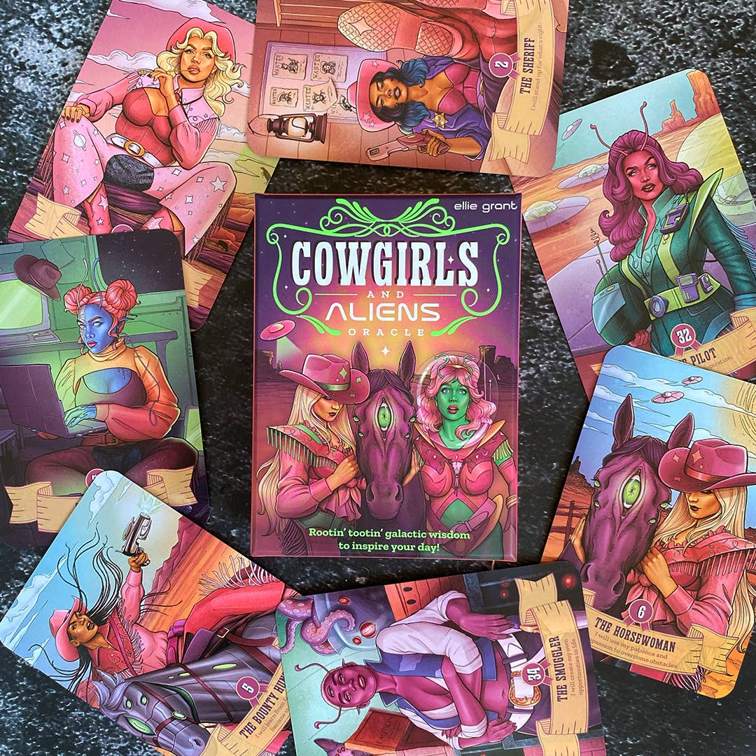 Cowgirls and Aliens Oracle deck box by Ellie Grant surrounded by 10 cards fanned out on a dark surface, showing characters including The Sheriff (2), The Pilot (32), The Horsewoman (6), The Smuggler (30), and The Bounty Hunter (8)