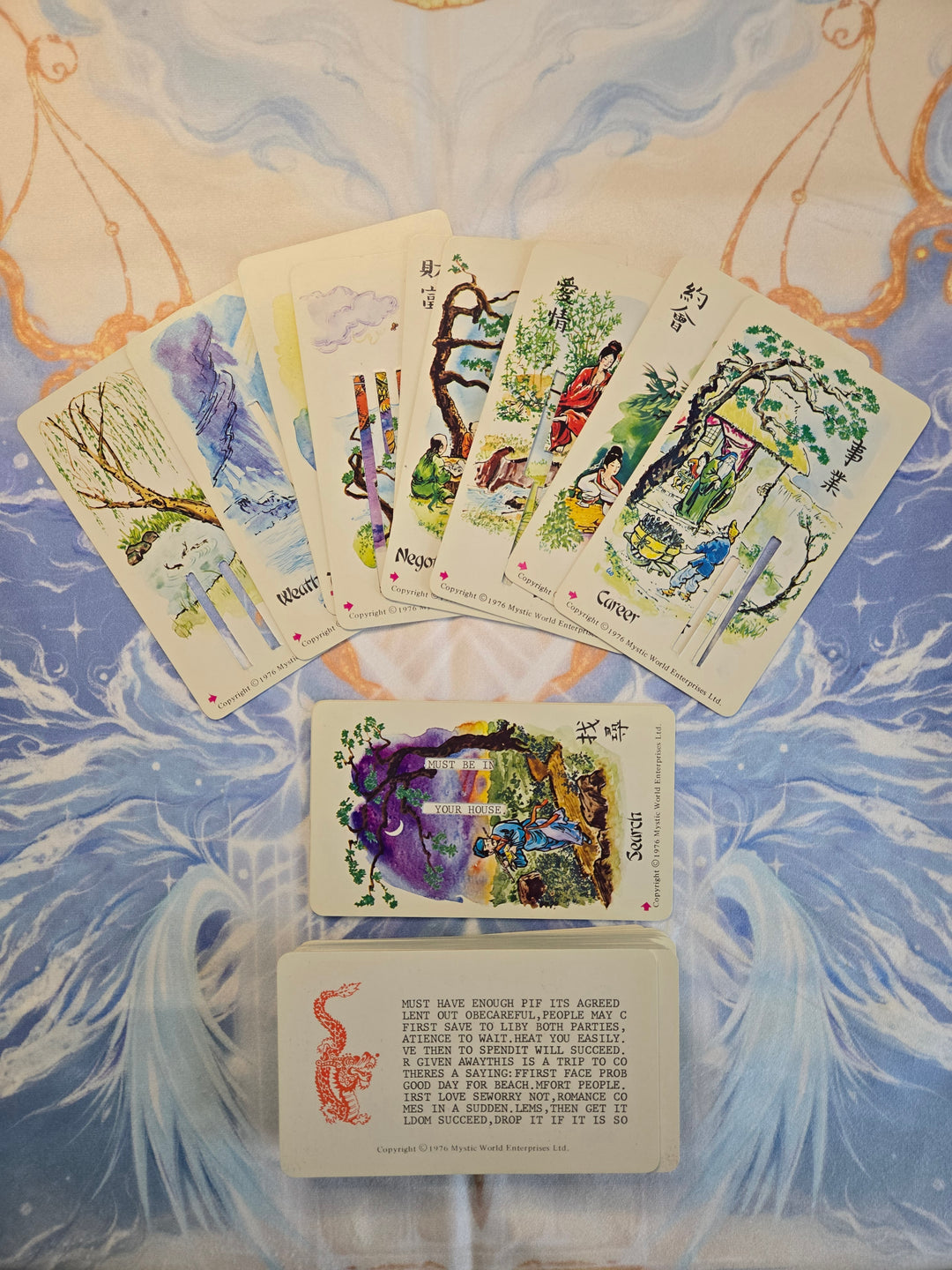 Dragon Mystique Chinese Fortune Cards spread showing theme cards fanned above answer cards with fortune text visible — 1976 Mystic World Enterprises vintage divination set