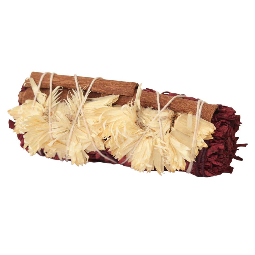 White sage smudge stick with dragon's blood resin, cinnamon, and white strawflowers for protection rituals