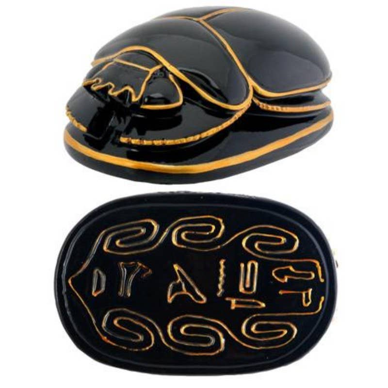 Egyptian black and gold scarab figurine shown from top and bottom, displaying detailed resin finish and hieroglyphics on the base