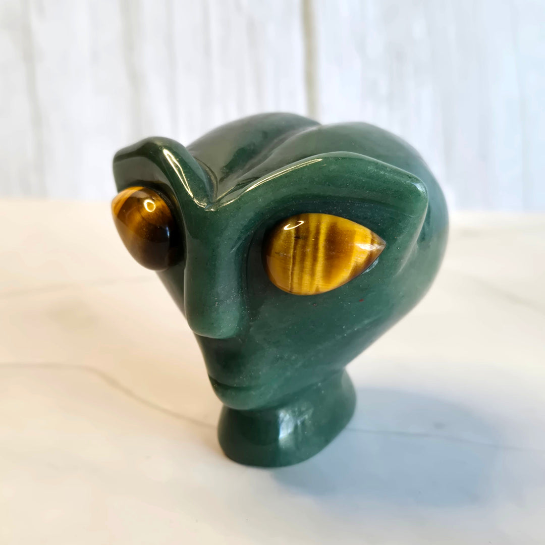 Hand-carved green aventurine alien head with tiger eye stone eyes, 2.25 inch crystal carving