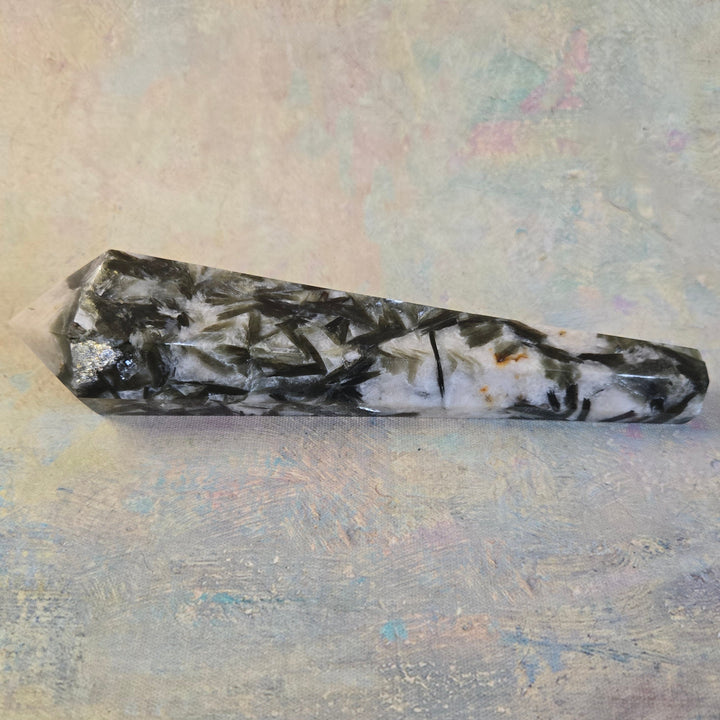 Green mica and quartz crystal wand point styled flat lay