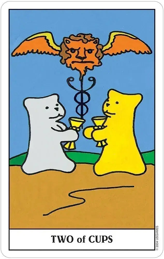 Two of Cups card from Gummy Bear Tarot, showing white and yellow gummy bears holding golden cups beneath a winged lion’s head.