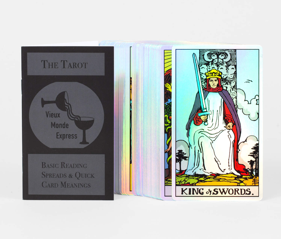 Holo Tarot 78-card holographic deck fanned showing iridescent card edges with King of Swords and Vieux Monde Express guidebook