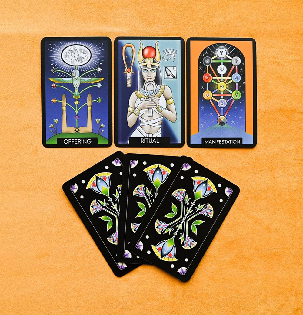 Initiates Oracle cards fanned out showing occult and Egyptian-inspired artwork