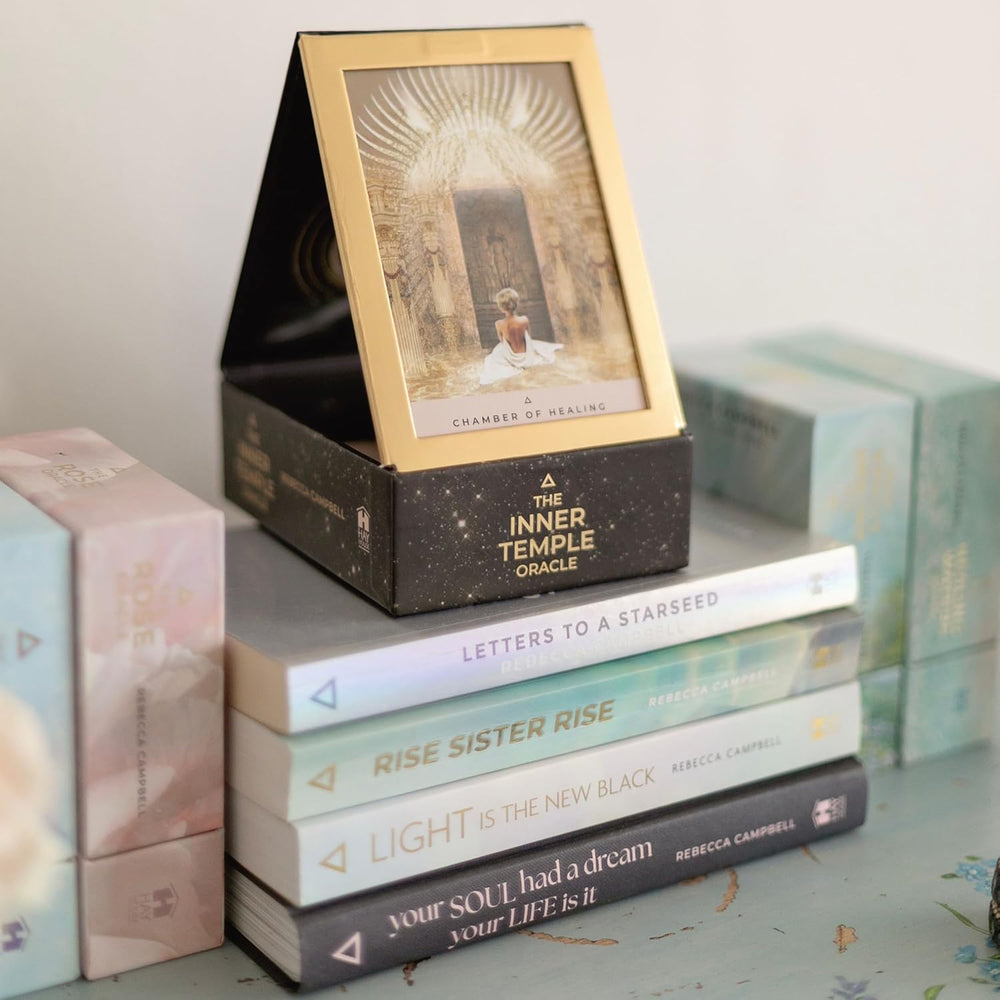 The Inner Temple Oracle deck box open with fold-out stand displaying a card — unique packaging design by Rebecca Campbell