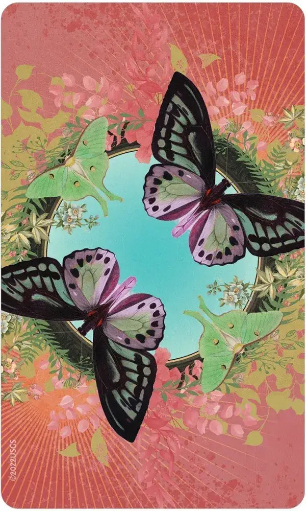 Love Who You Are Oracle card back — two large black and purple butterflies and green luna moths in a floral wreath on a coral pink sunburst background