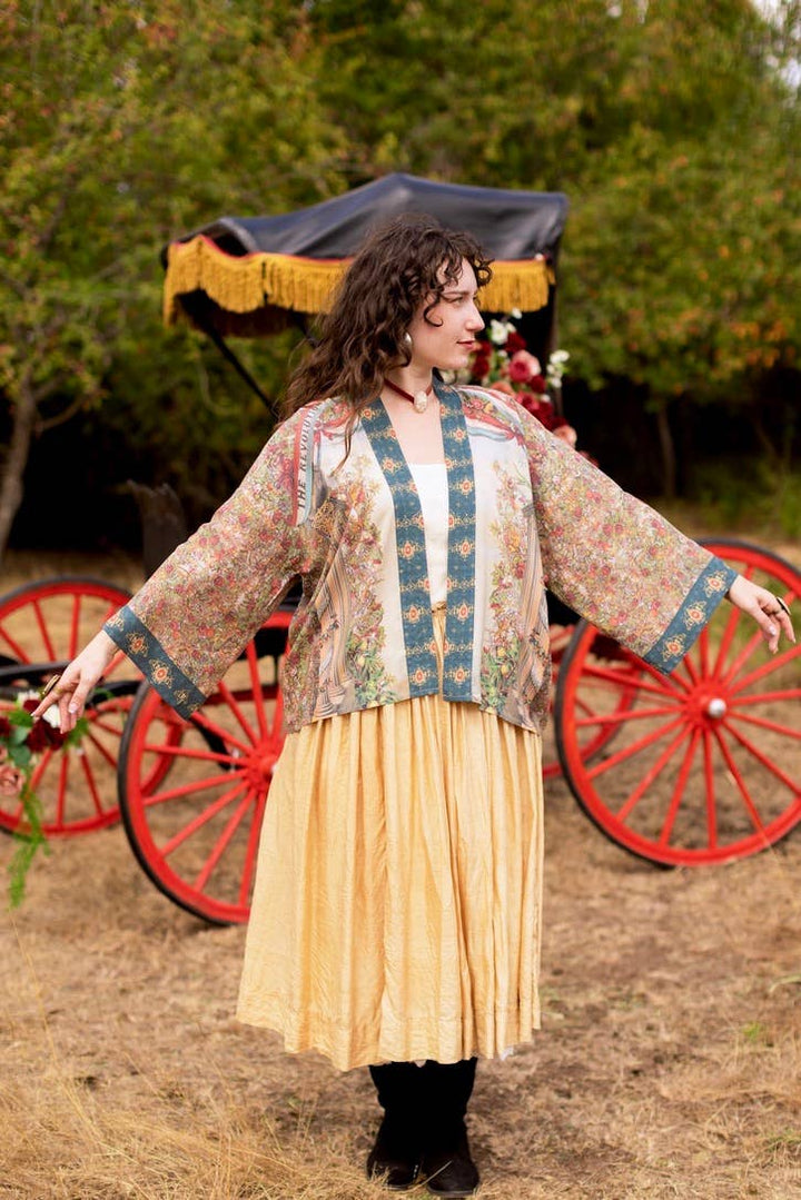 Front detail of Market of Stars Love Revolution crop kimono showing fabric drape, viscose texture, and vintage-inspired colorway of faded red, blue, and ivory