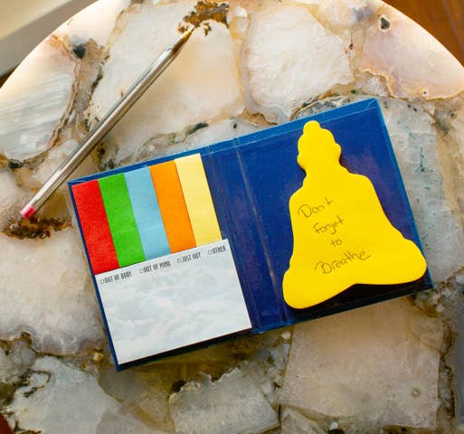 Open Notes of the Buddha sticky notes booklet showing golden Buddha-shaped note with handwritten Don&