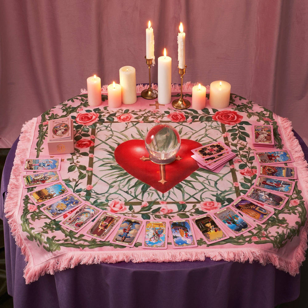 Renaissance Fantasy Tarot Cloth Sacred Heart styled as altar reading table with full tarot card spread, crystal ball, candles, and tarot deck box on blush pink tassel fringe cloth