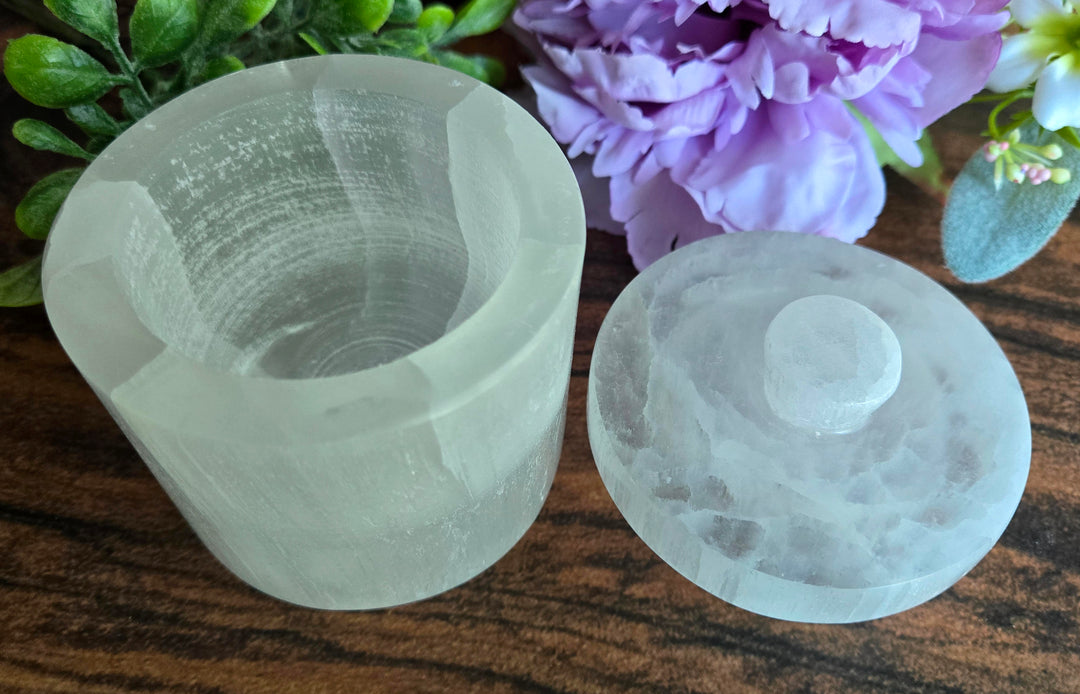 Selenite charging jar displayed on altar for sacred crystal and jewelry storage