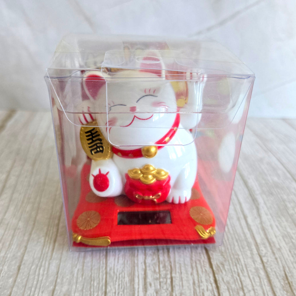Solar powered Maneki-Neko lucky cat in gift box ready to wave