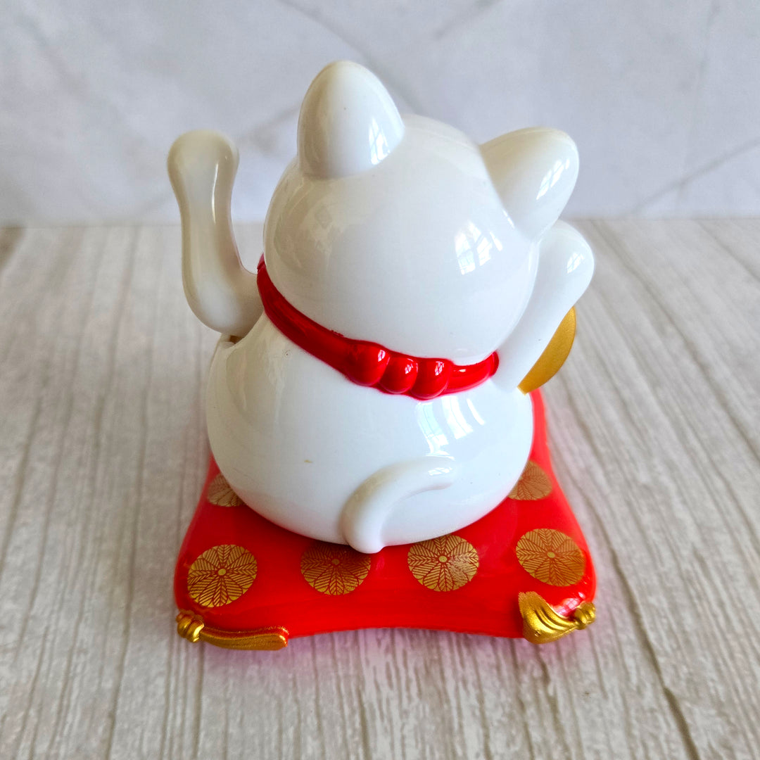 Back view of solar powered lucky cat showing solar panel no batteries required
