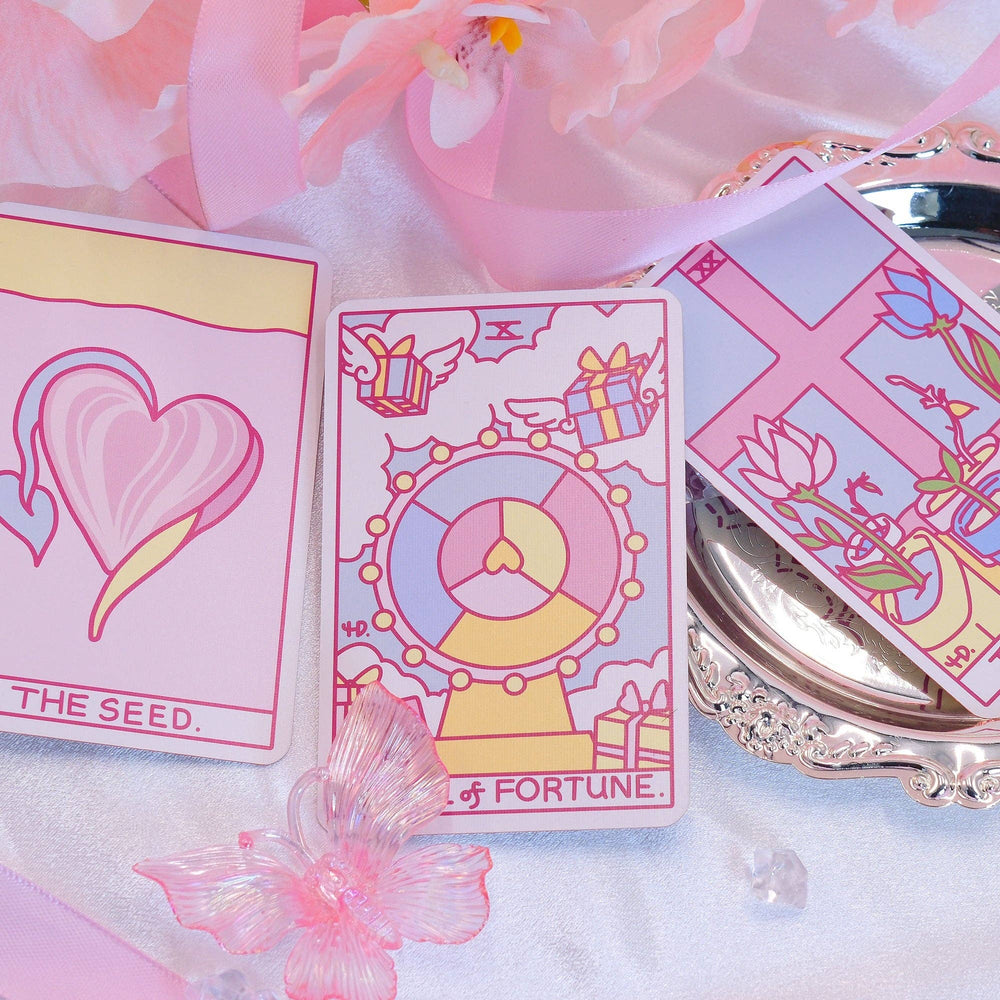 Strange Daisy Tarot 79-card deck spread showing whimsical Rider-Waite inspired artwork in pink and The Seed card