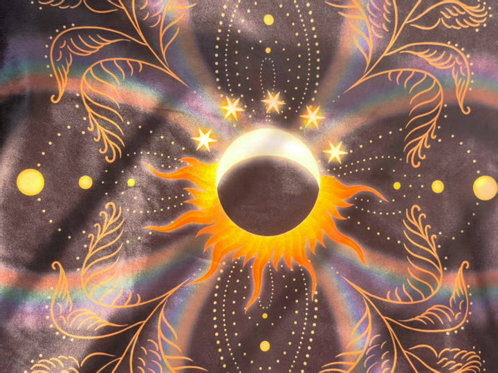 Close-up of Sun and Moon Tarot Cloth showing glowing solar eclipse and crescent moon motif with gold star accents on soft flannel fabric