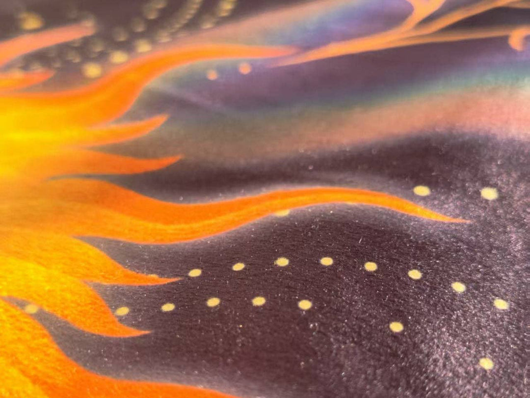 Macro close-up of Sun and Moon Tarot Cloth flannel fabric texture showing orange sun flame detail and gold dot star pattern