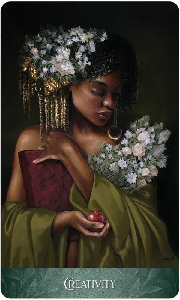 Creativity card from The Luminescent Oracle, showing a woman adorned with white flowers holding a red book and a pomegranate.
