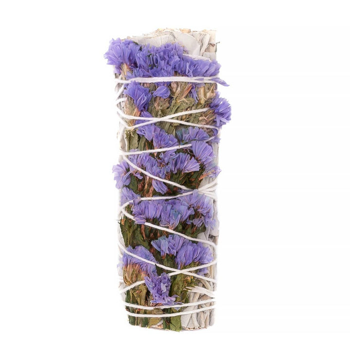 Close-up of purple Statice flowers bundled with sustainably harvested California white sage leaves for smudging