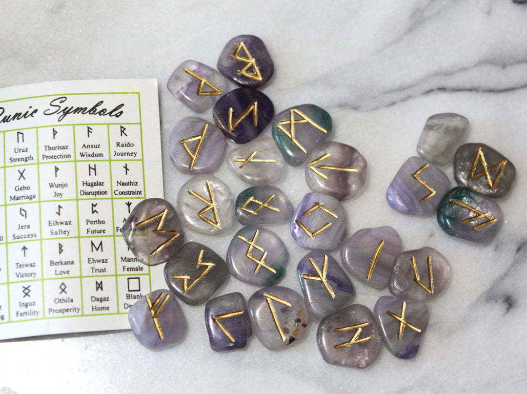 Fluorite Elder Futhark rune stones scattered with symbol reference card — Viking rune set by Healing Winds Emporium