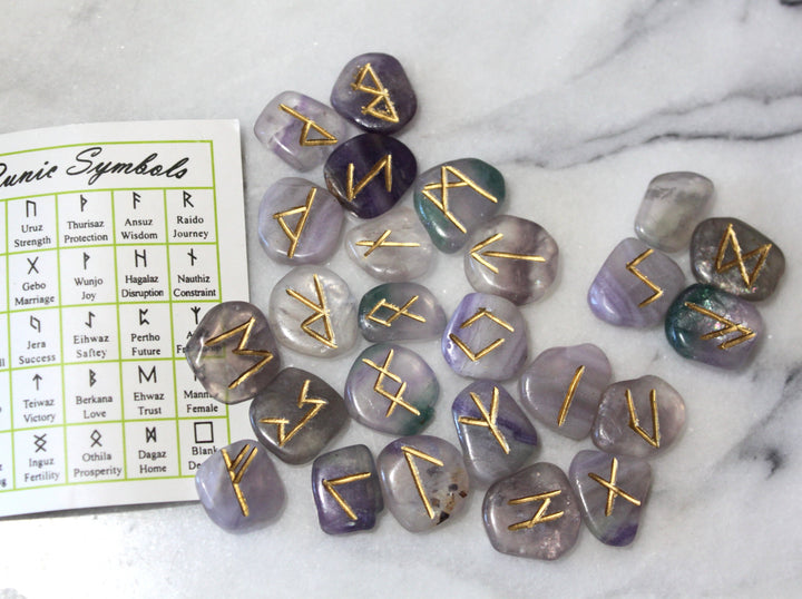 Fluorite Elder Futhark rune stones scattered with symbol reference card — Viking rune set by Healing Winds Emporium